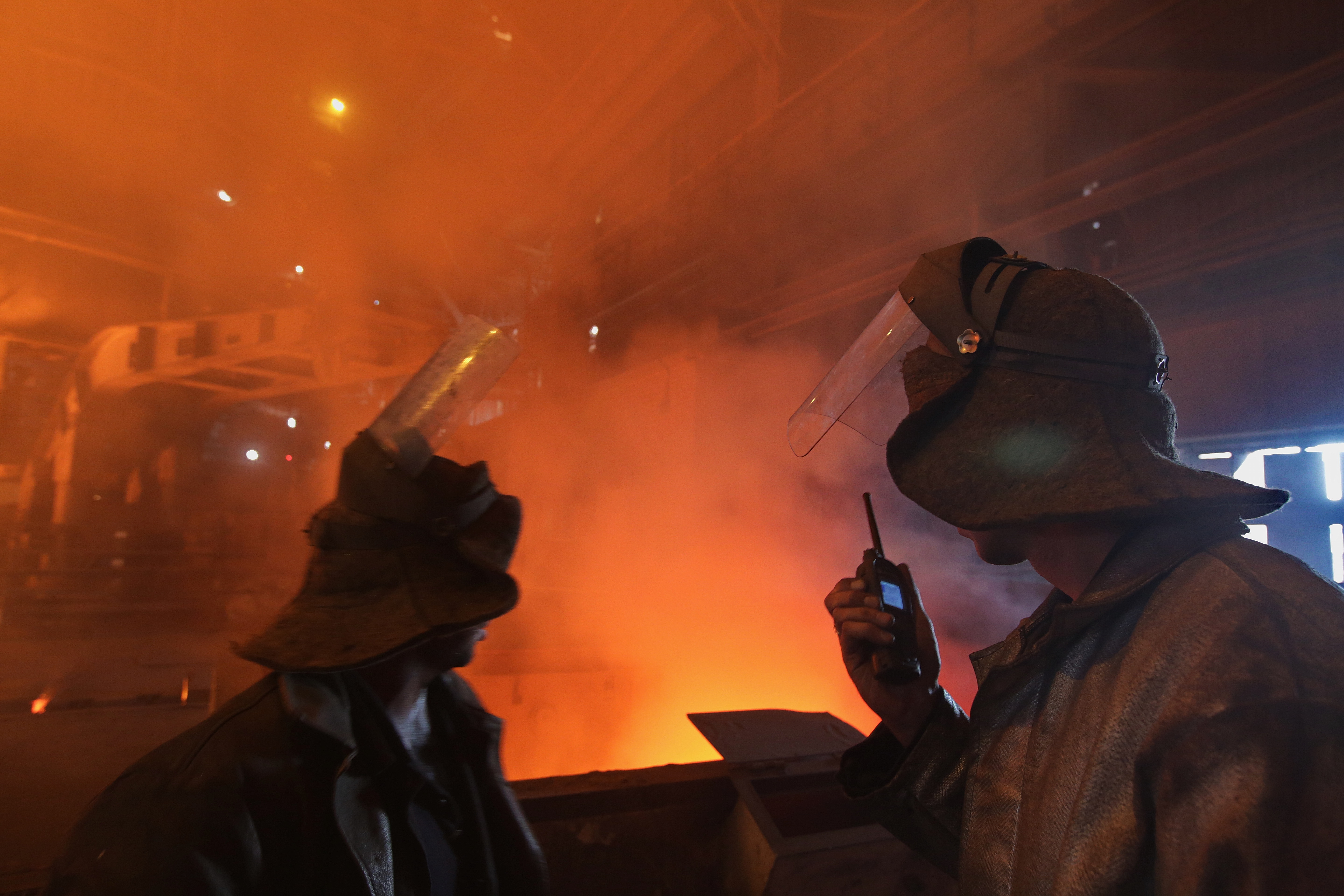 Steelworkers at ArcelorMittal Kryvyi Rih confer inside a blast furnace at the factory. 
