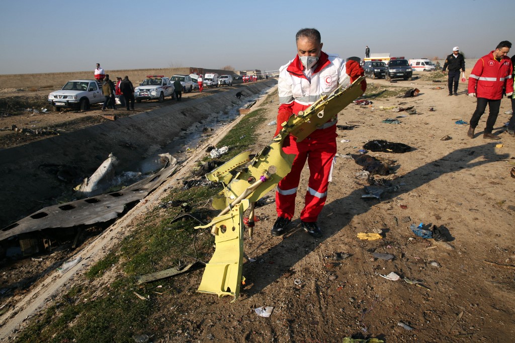 Rescue teams recover debris from a field after a Ukrainian plane carrying 176 passengers crashed near Imam Khomeini airport in the Iranian capital Tehran early in the morning on Jan. 8, 2020, killing everyone on board.
