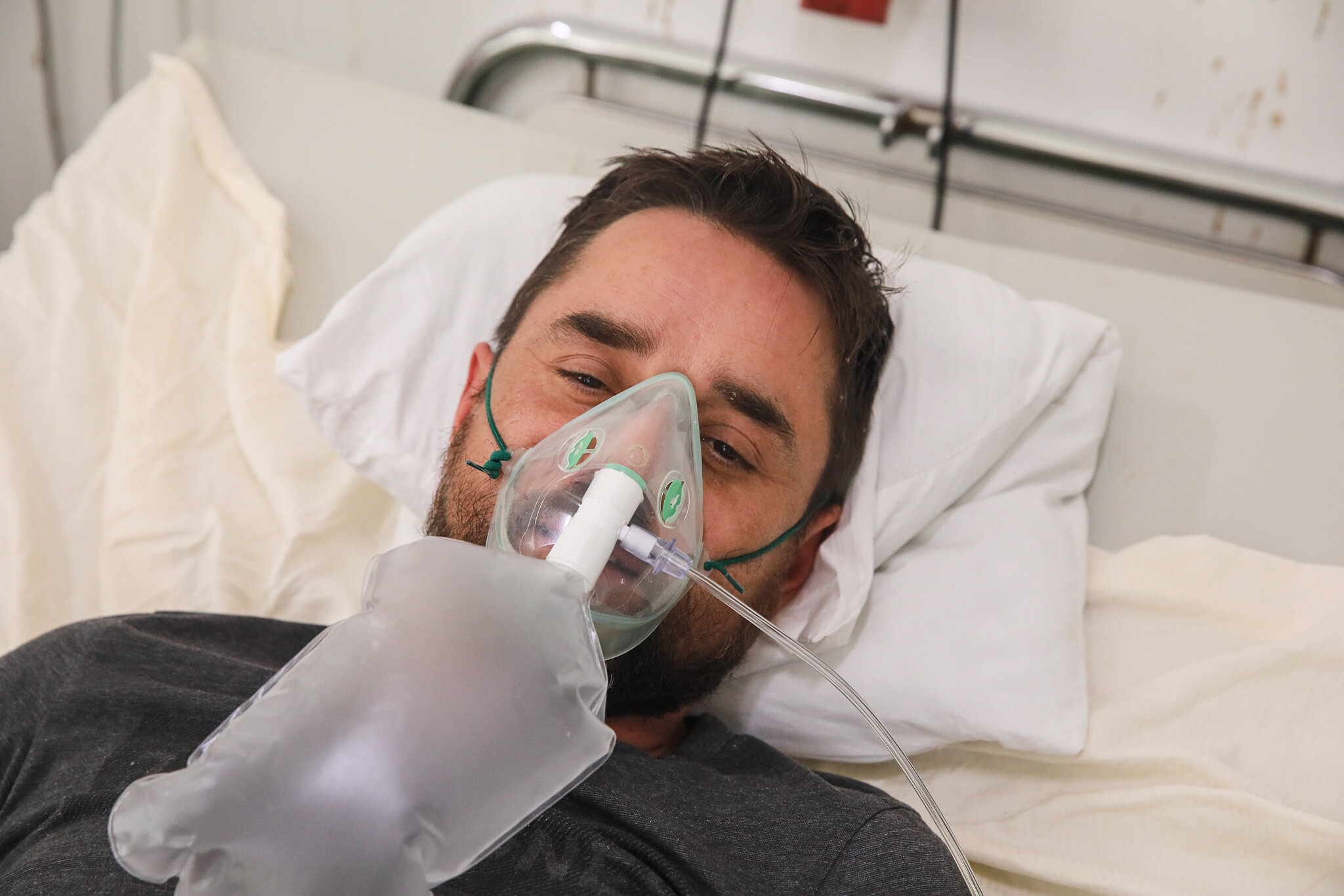 Taras Biyovsky, a patient and a father of five, is lying on the hospital bed wearing an oxygen mask in intensive care unit at Kolomyia District Hospital in Ivano-Frankivsk Oblast on March 16, 2021.