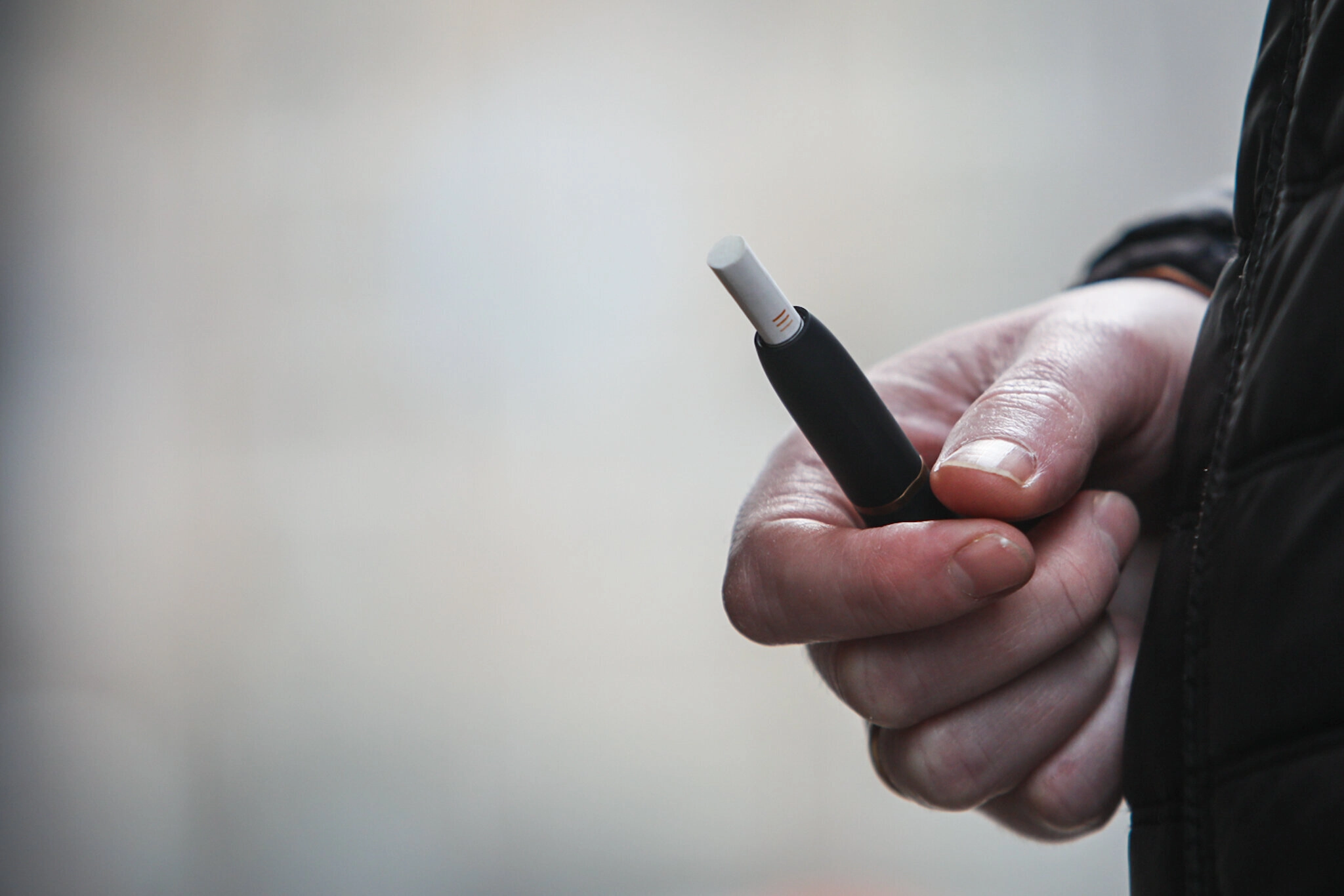 A man is puffing his IQOS device on the streets of Kyiv during a national-wide lockdown in early May. 