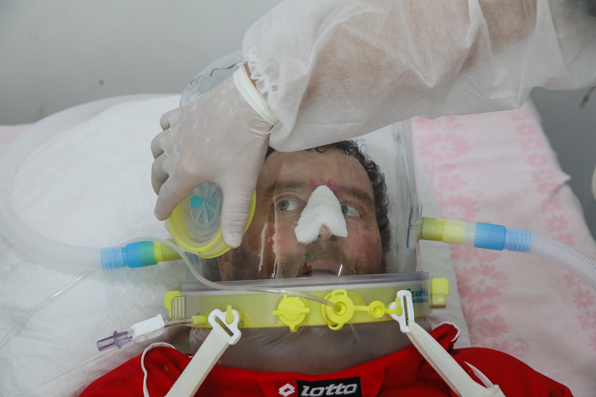 COVID-19 patient Vasyl wears a helmet supplying him with oxygen-enriched air at Kolomyia District Hospital in Ivano-Frankivsk Oblast on March 16, 2021. Vasyl has been in intensive care for nearly three months.