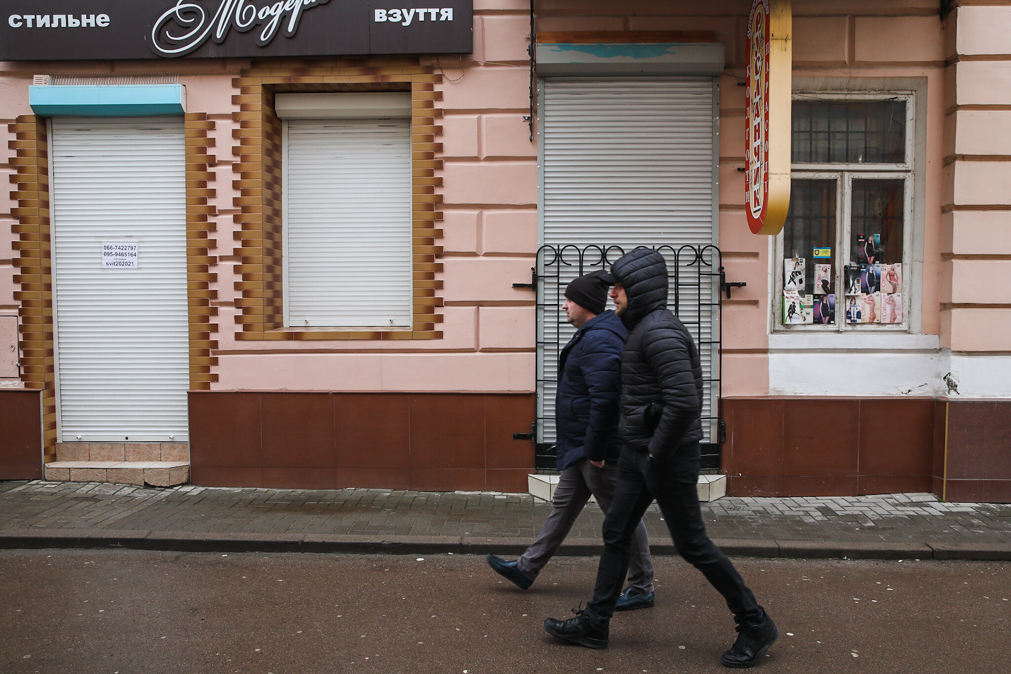 People walk along the streets of the central Kolomyia in Ivano-Frankivsk Oblast on March 16, 2021. All non-essential shops and businesses are closed. 