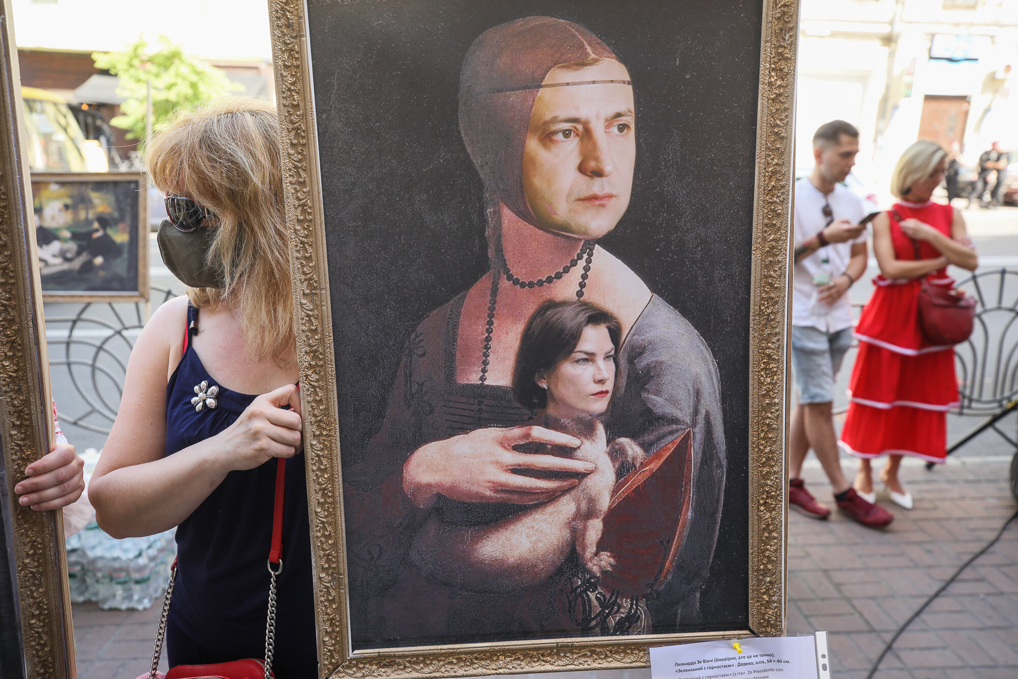 Activists and supporters of the European Solidarity political party and Petro Poroshenko hold mockup pictures of classic art masterpieces with the faces of Prosecutor General Iryna Venediktova and President Volodymyr Zelensky during a rally in front of the State Investigation Bureau in downtown Kyiv on June 10, 2020.