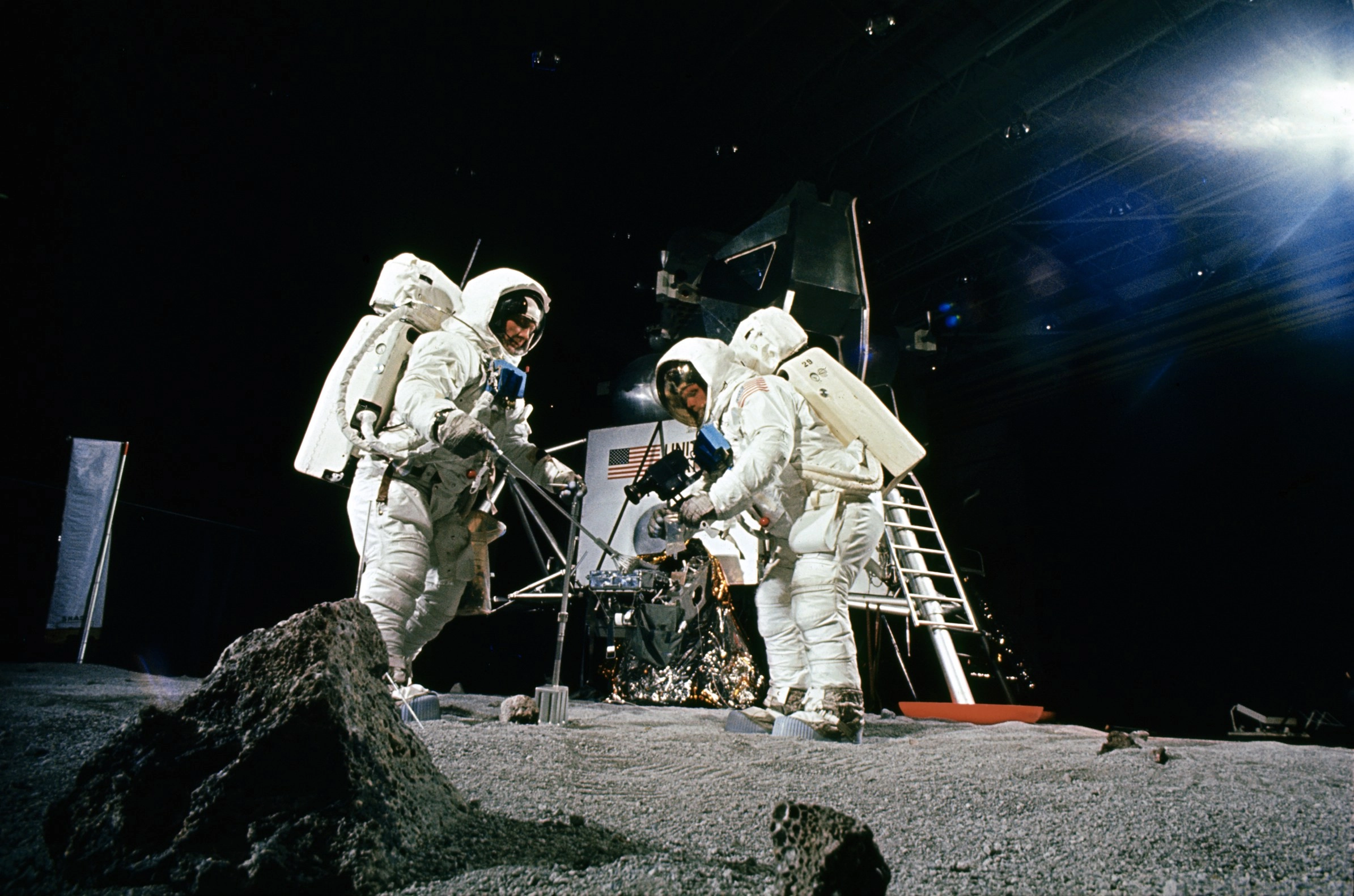 Astronauts Neil Armstrong and Buzz Aldrin practice collecting soil samples at a NASA training facility in April 1969.