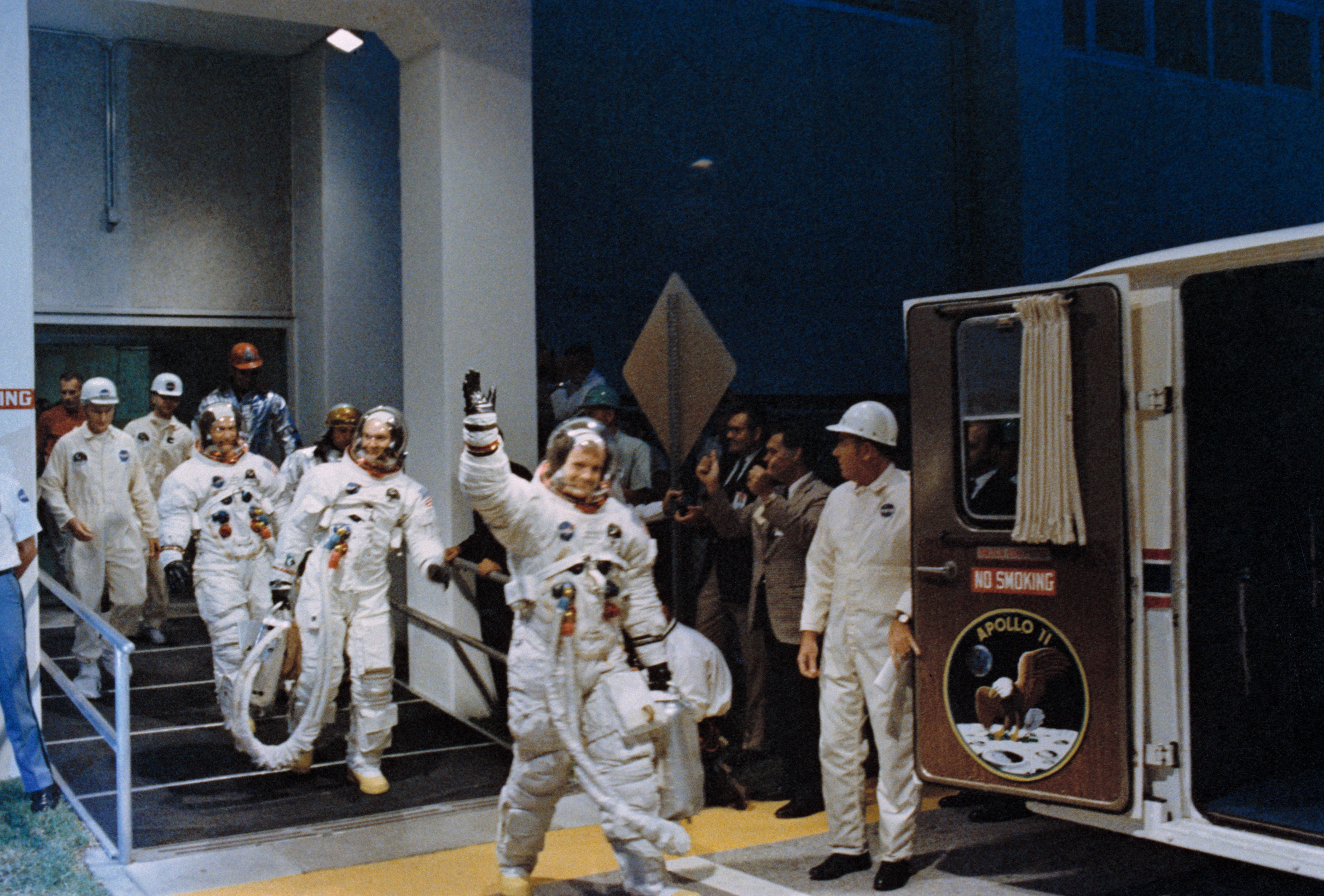 Apollo 11 astronauts wave at NASA personnel as they prepare to kick-start the mission on July 16, 1969.