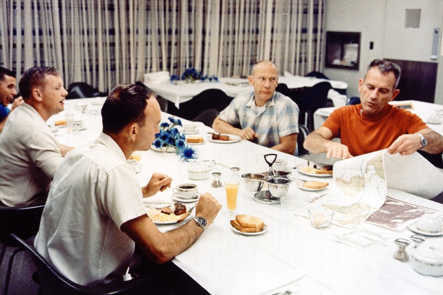 Apollo 11 astronauts have a traditional early breakfast with the mission Deke Slayton (R) just hours before the historic start on July 16, 1969.
