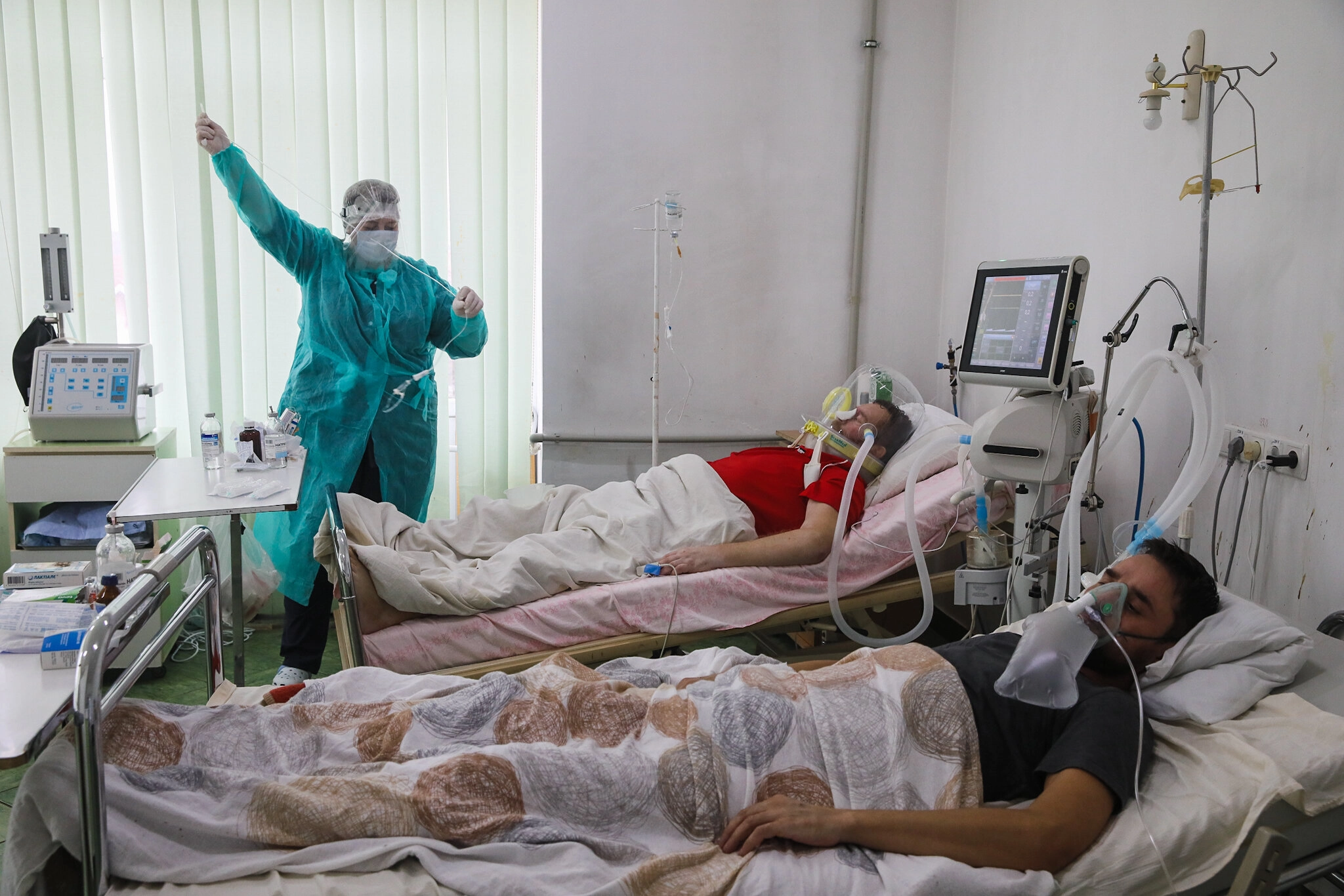 Patients Vasyl and Taras are neighbors in the intensive care unit for patients with COVID-19 at Kolomyia District Hospital in Ivano-Frankivsk Oblast on March 16, 2021.