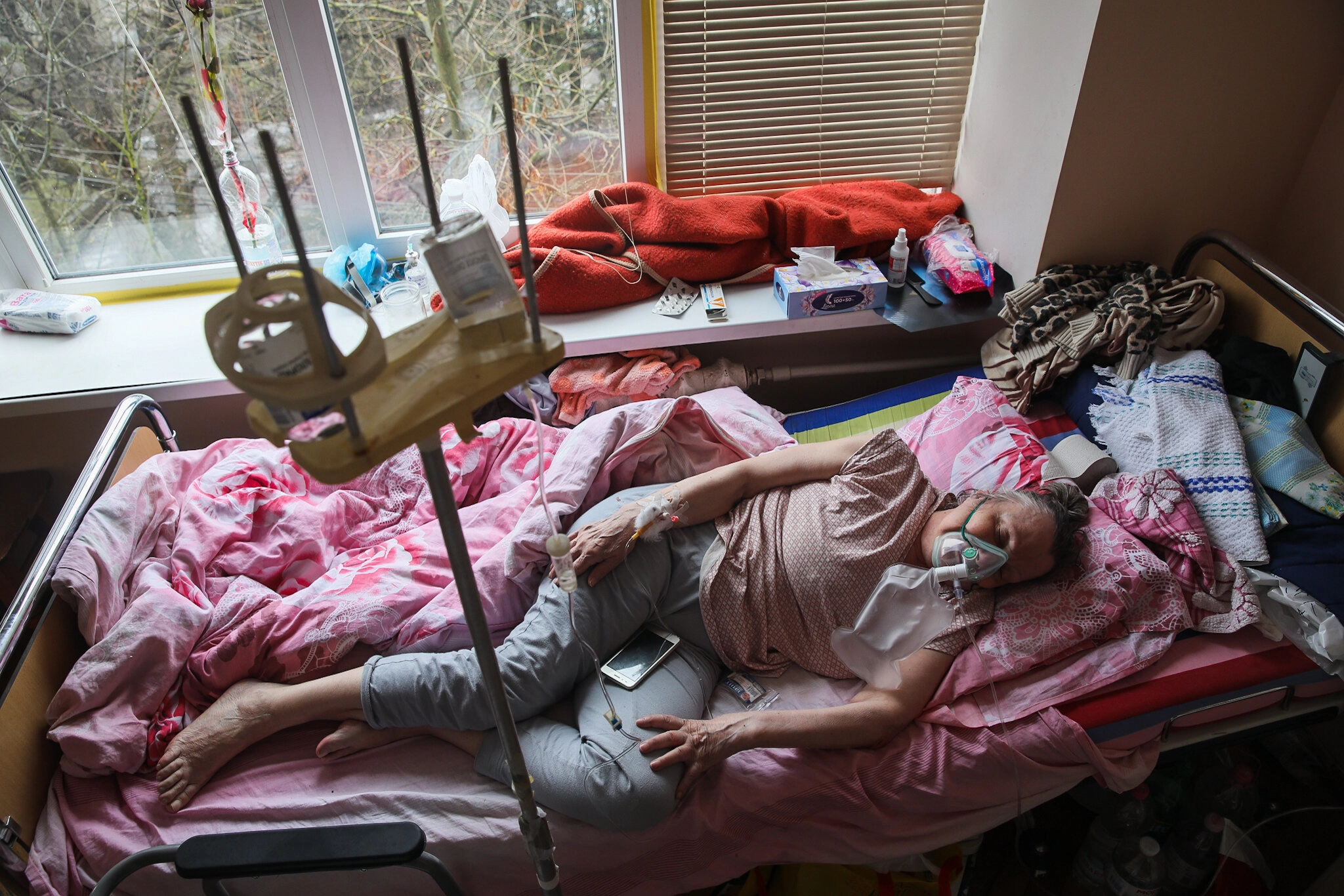 Patients in oxygen masks rest at Kolomyia District Hospital in Ivano-Frankivsk Oblast, on March 16, 2021. The hospital fits 175 COVID-19 patients.