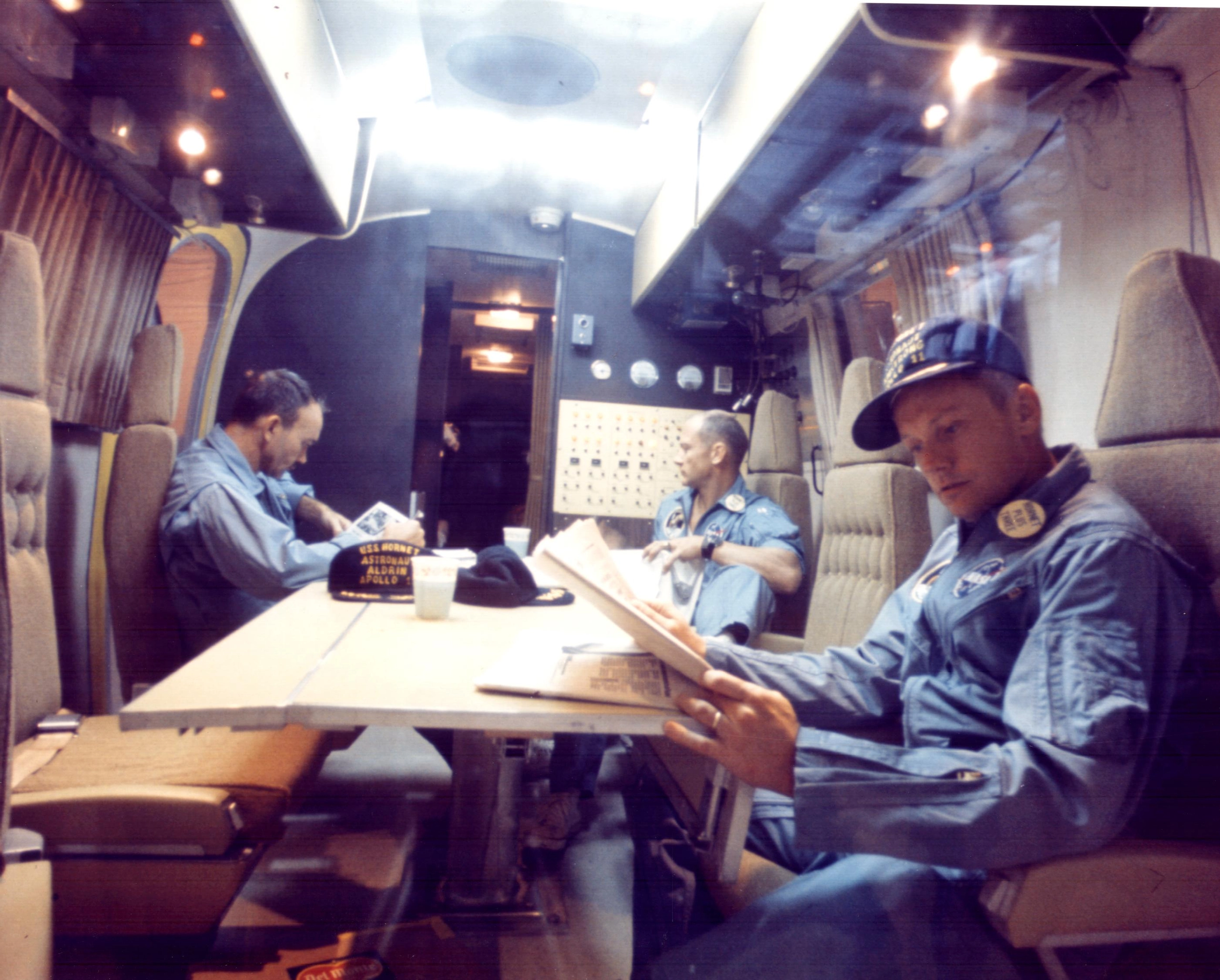 Apollo 11 astronauts have a rest at a biological protection wagon shortly after being recovered by USS Hornet on July 24, 1969.