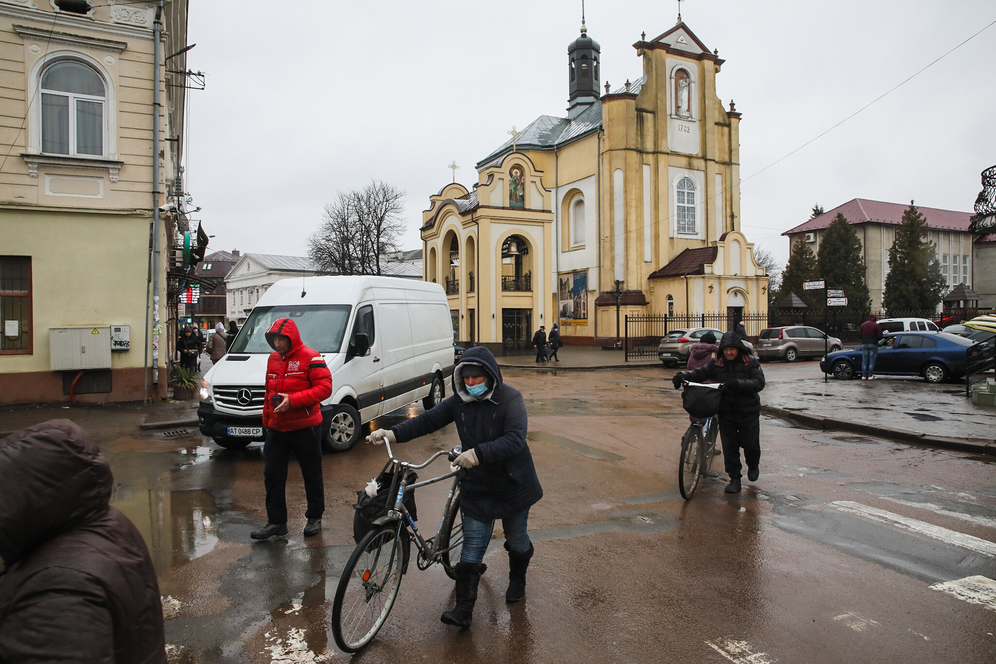 People walk along the streets of Kolomyia, a city in Ivano-Frankivsk Oblast, on March 16, 2021. The area is hit hard by coronavirus. 