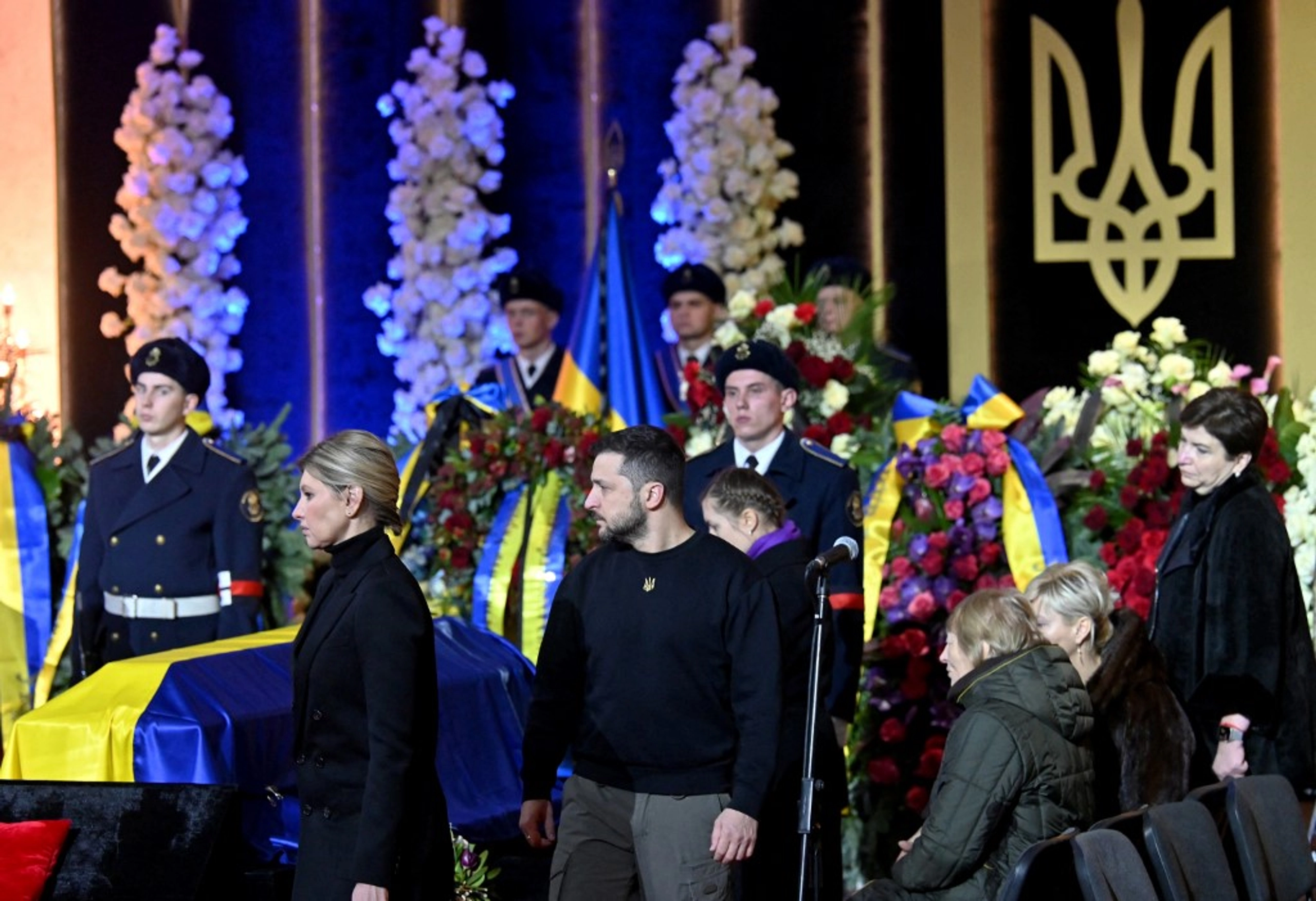 Ukrainian President Volodymyr Zelensky and his wife Olena offer relatives their condolences during the funeral ceremony of Ukrainian Interior Minister Denys Monastyrsky and other employees of his department at the Ukrainian House in Kyiv on January 21, 2023. Sergei SUPINSKY / AFP