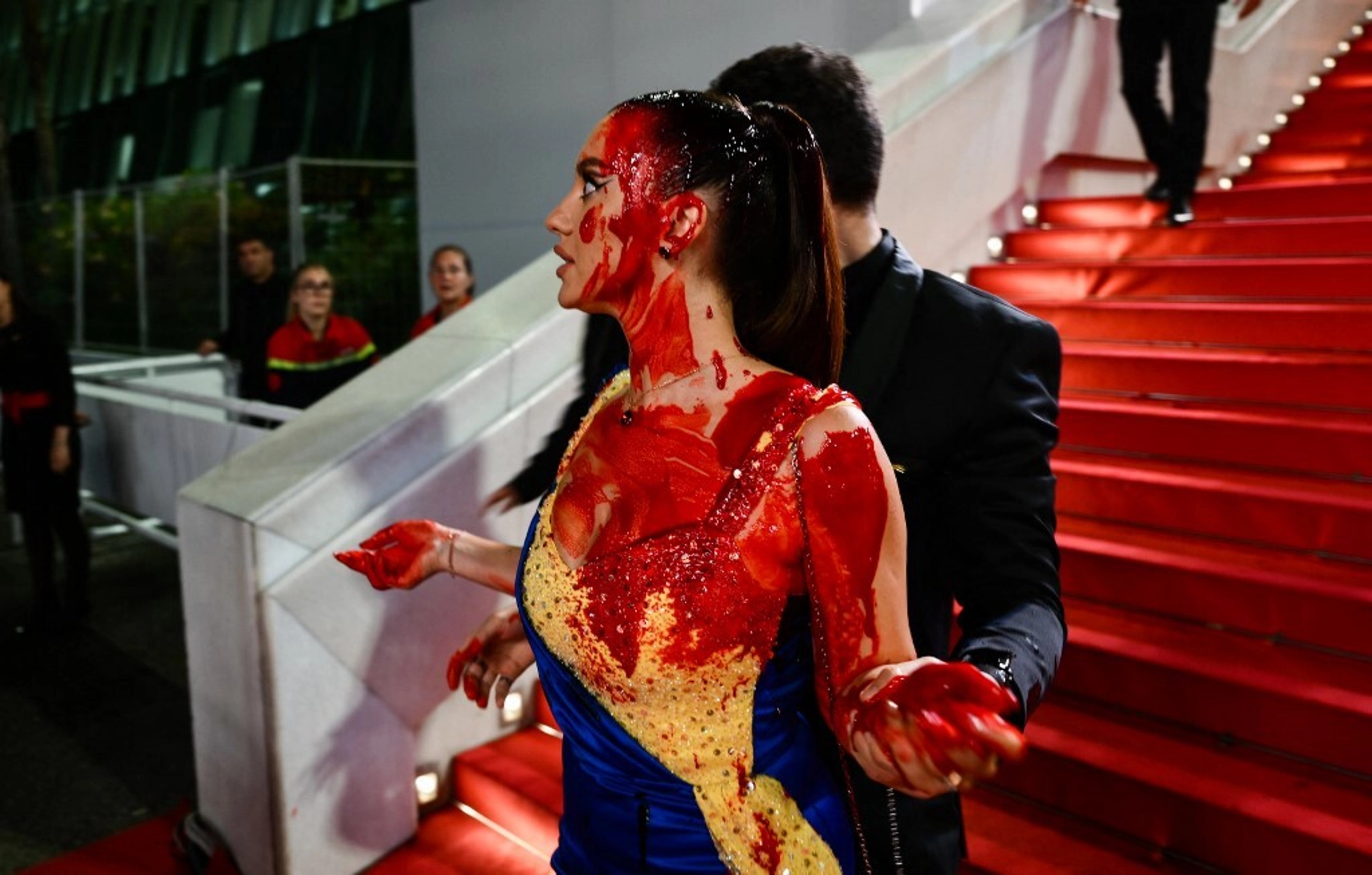 Cannes Protester in Ukrainian Colors Covers Herself with Fake Blood on Red Carpet