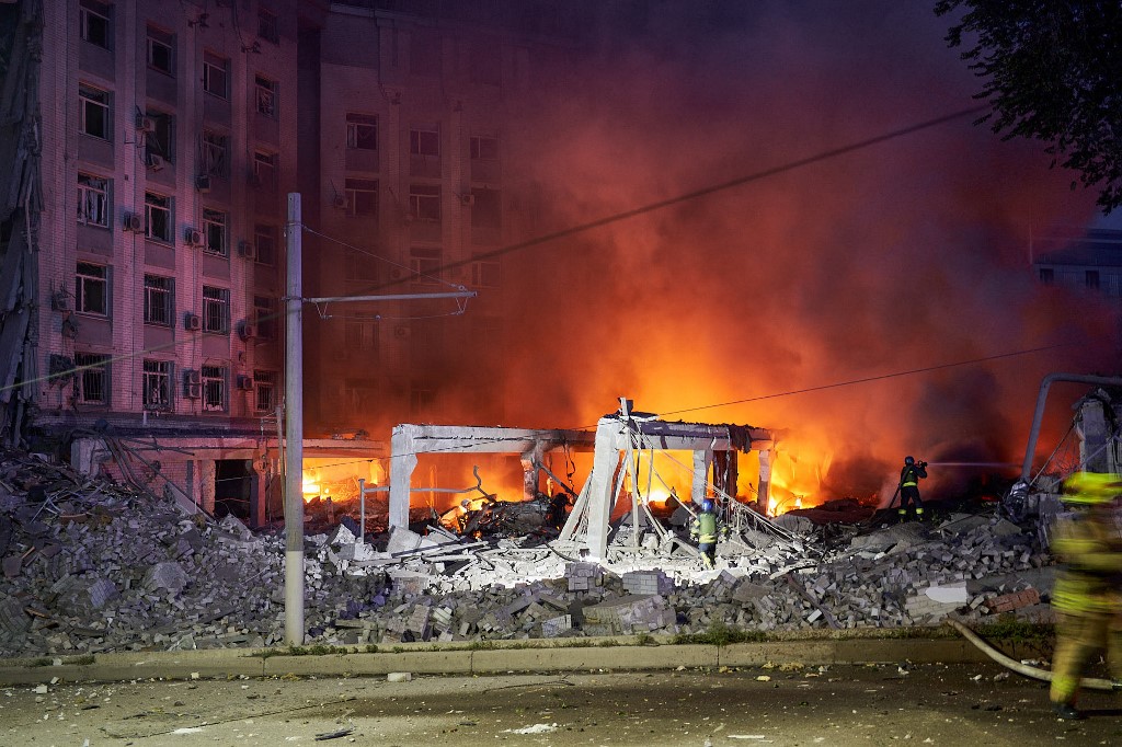 Ukrainian firefighters push out a fire in an administrative building after missiles strike in Dnipro on July 28, 2023. Vitalii  Matokha / AFP