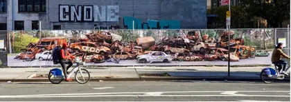 ‘Please Don’t Forget Us’ – Irpin’s Car Cemetery Artwork Erected in Manhattan