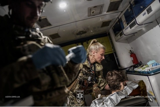 Medic treating battle casualty, 12th National Guard Brigade “Azov”, combat image published by unit.