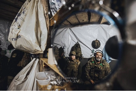 Guardsmen in a dugout (reflected in mirror), 15th National Guard Brigade “Kara Dah”, recruiting image.
