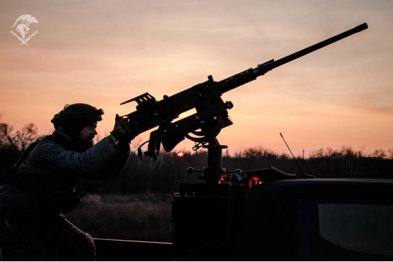 Law enforcer on military duty aims with an M2 .50 machine gun to engage incoming Russian drones, very pretty photograph recorded by 18th “Sloviansk” National Guard Brigade.