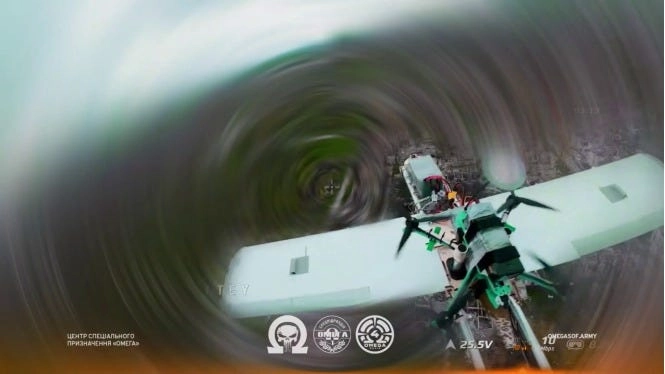 Image by the Ukrainian drone group Omega of a Russian drone carrying a Russian FPV drone, about to be shot down by a Ukrainian interceptor drone (Image info in watermark)